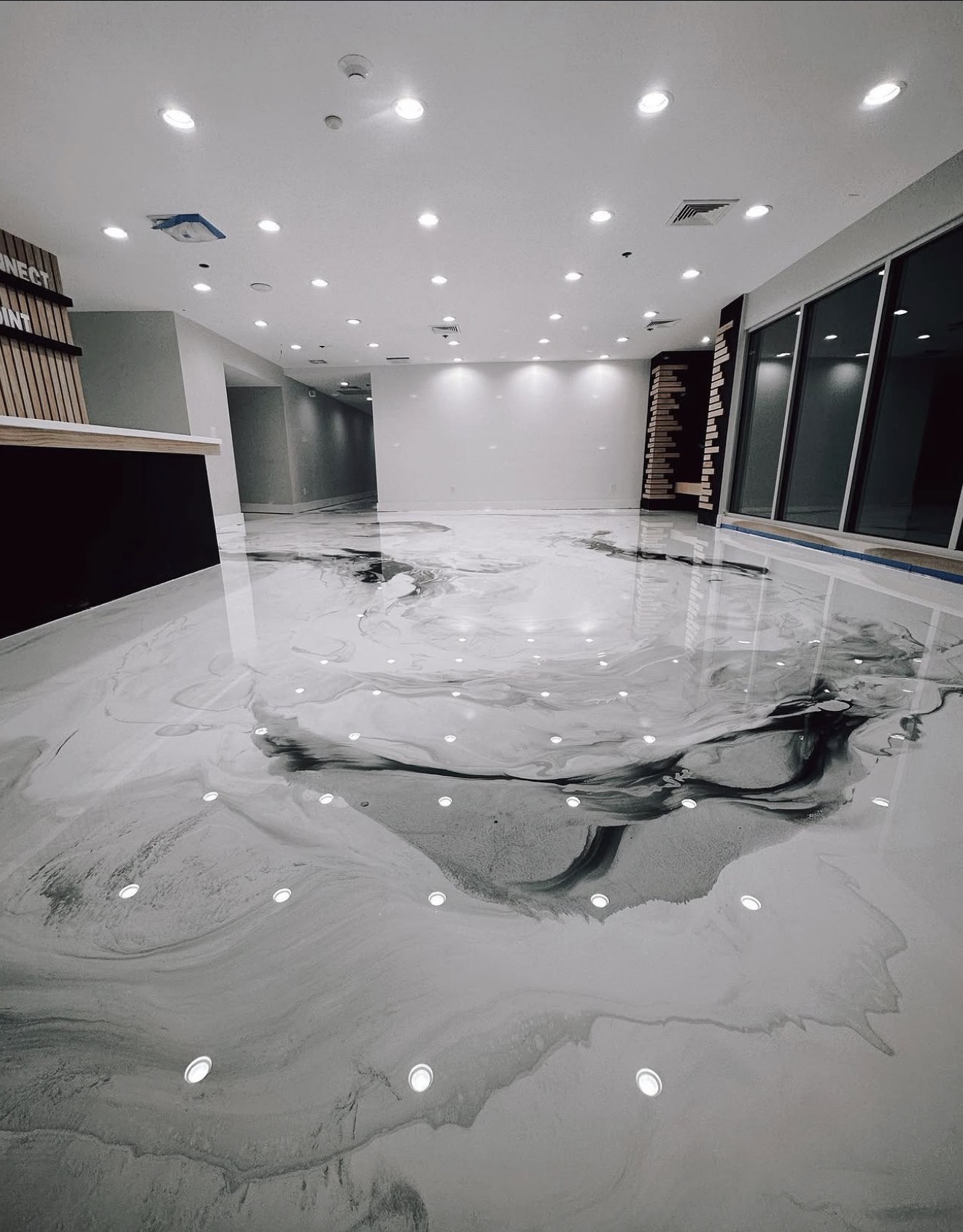 Pearl white and charcoal metallic flake floor in a commercial lobby